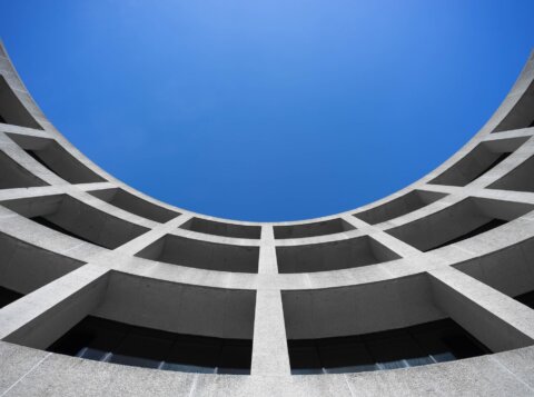 low angle photography of gray concrete building at day time