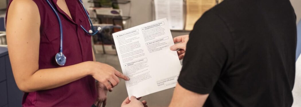 woman in black shirt holding white printer paper