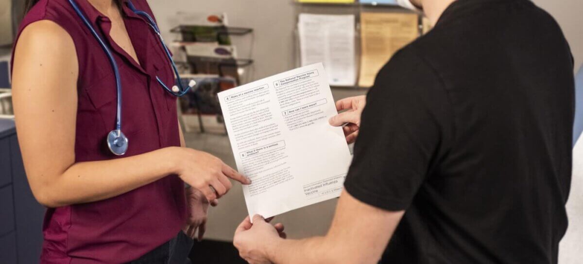 woman in black shirt holding white printer paper