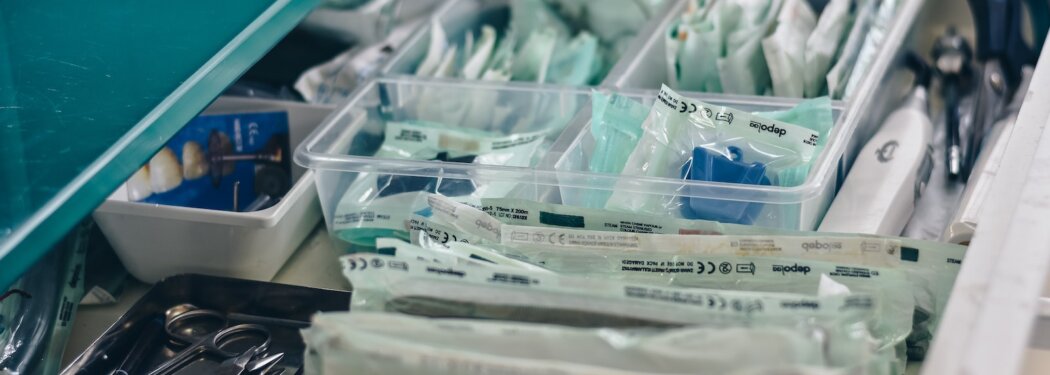 white packs with scissors and medicine on gray tray