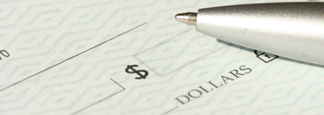 a pen sitting on top of a cheque paper