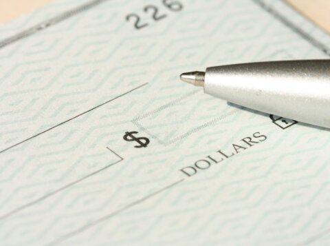 a pen sitting on top of a cheque paper