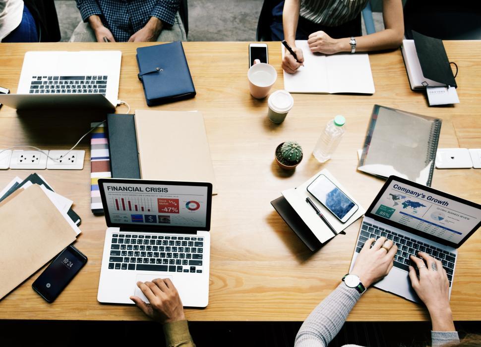 overhead-view-of-a-meeting-table-with-coffee-and-computers - AArete