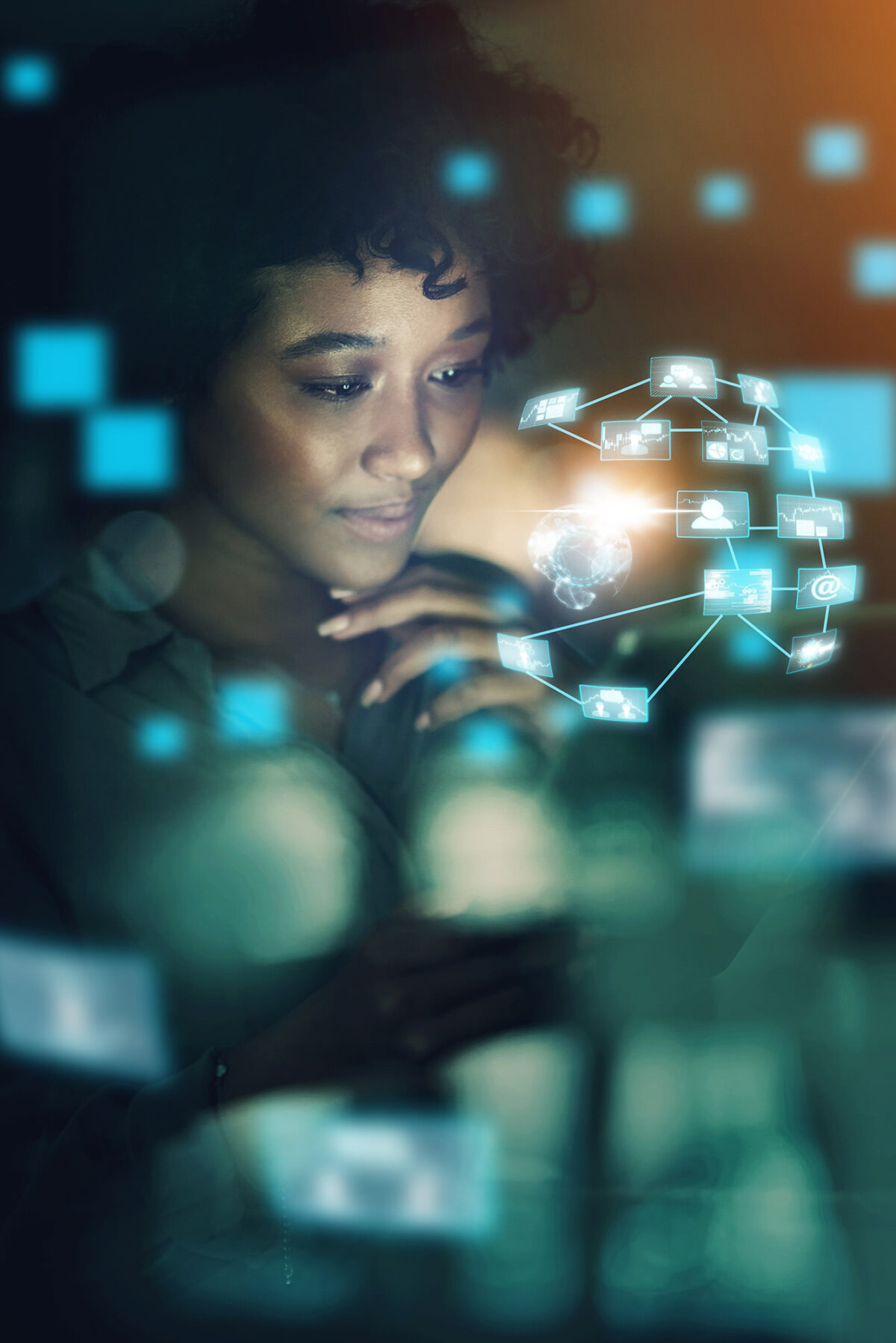 Woman looking at a holographic network diagram of connected icons and data nodes in blue, futuristic glow.