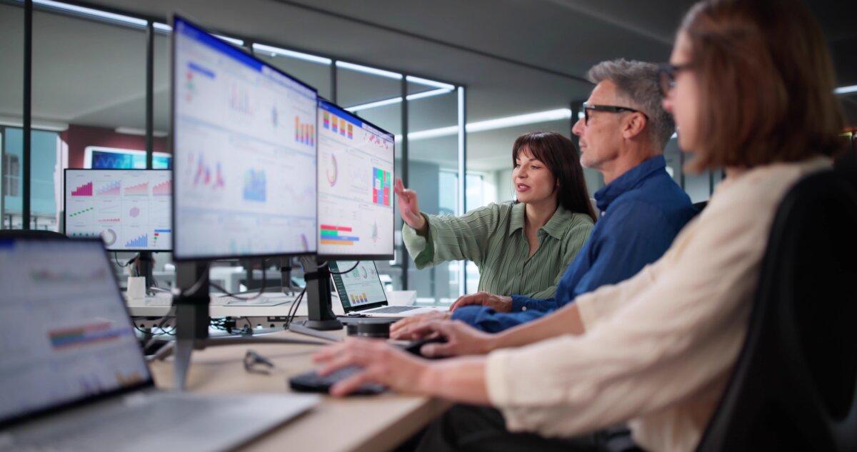 MulticulturalTeamAnalyzingPerformanceDataUsingKpiDashboardInOffice - AArete Tech Strategy Dashboard