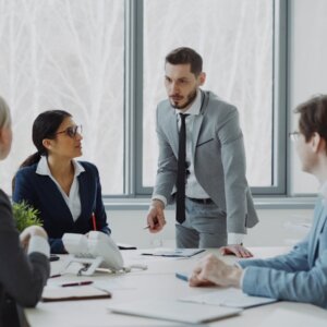 Business professionals in a meeting around a table.