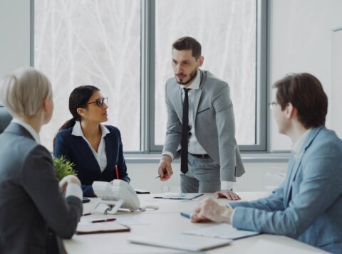 Business professionals in a meeting around a table.